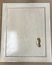 Cabinet door, before repair by Home Enhancements.
