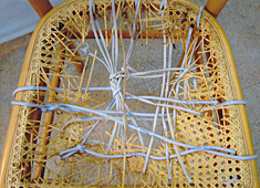 Woven chair seat detail, before repair by Home Enhancements.